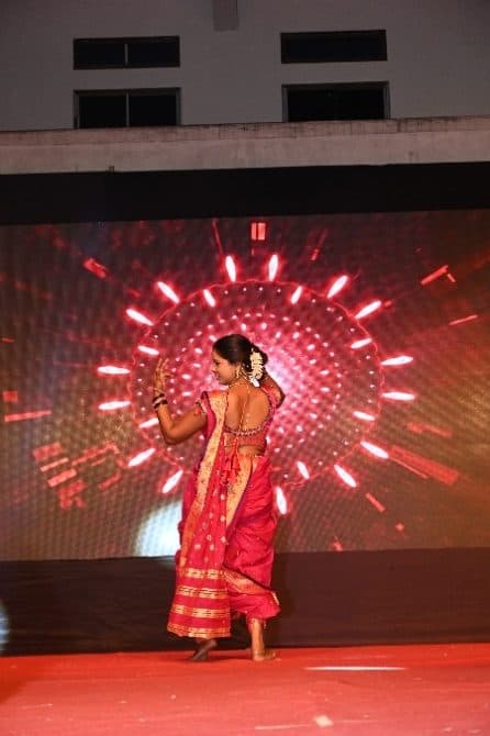 A student dancing on stage at the Annual Fashion Show and Annual Gathering 2026
