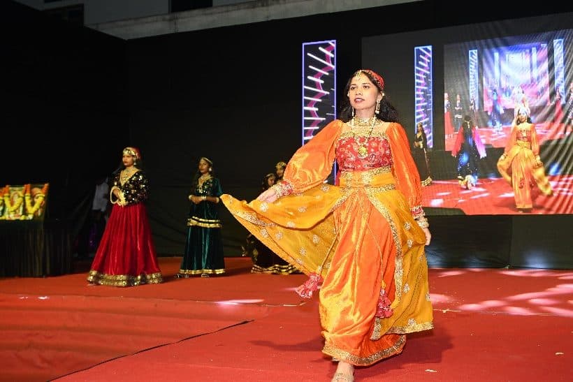 Students performing a dance in colourful costumes at the Annual Gathering 2026