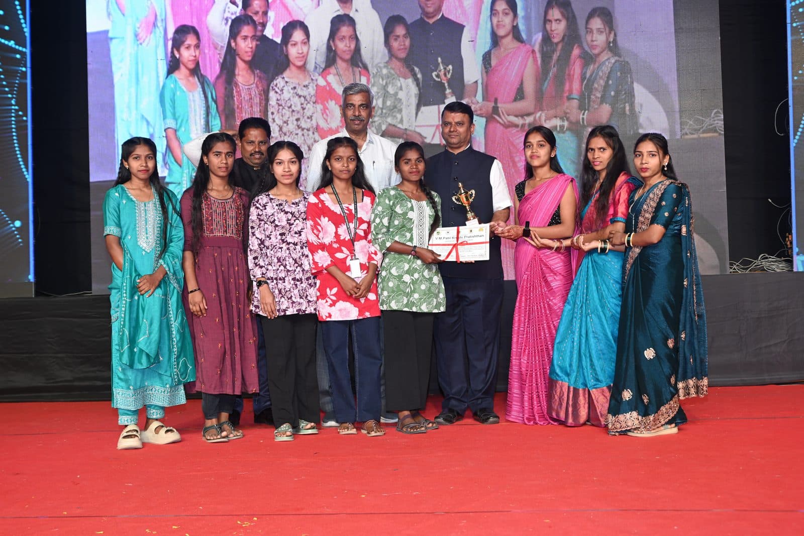 Students and guests on stage with a certificate at the Annual Fashion Show and Annual Gathering 2026