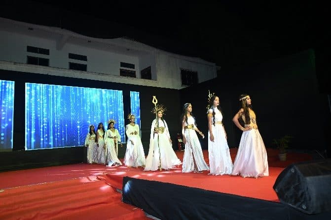 Models in white outfits walking the ramp at the Annual Fashion Show 2026