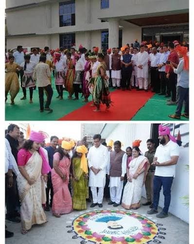 Guests and students at a campus inauguration, with a rangoli at the entrance