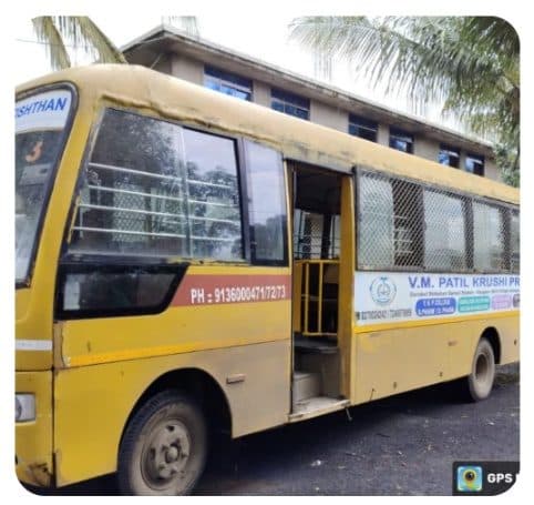 A yellow V. M. Patil Krushi Pratishthan college bus
