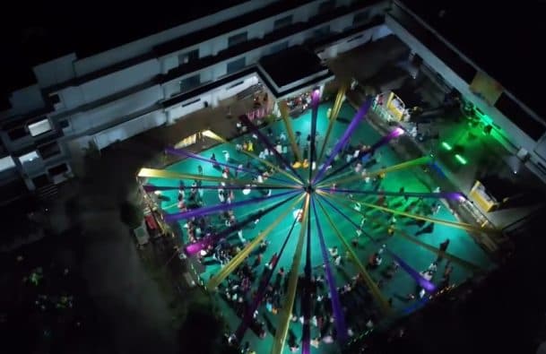 Aerial view of a lit stage at a college festival at night