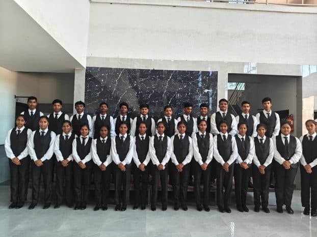 Students in food and beverage service uniform standing in rows