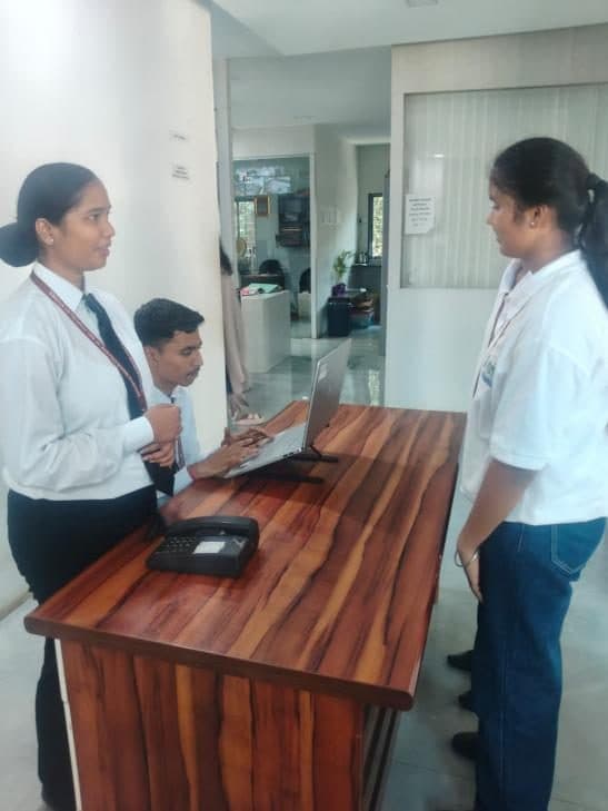Students role-playing guest check-in at the front office desk