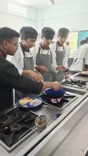 Students cooking at the range under supervision
