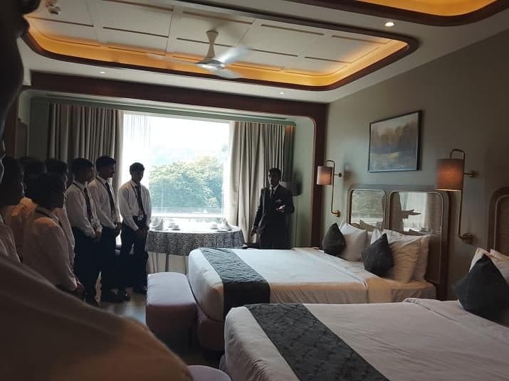 Students being shown a guest room during the industrial visit to The Fern Shelter Resort