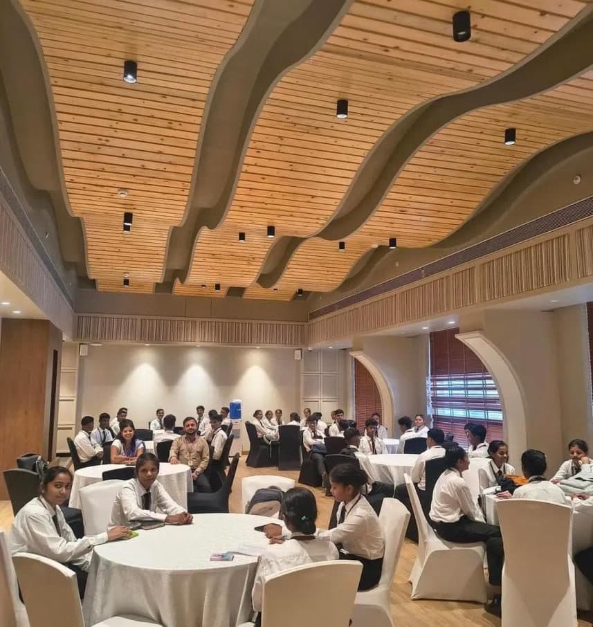 Students seated in a banquet hall during the Lemon Tree hotel visit