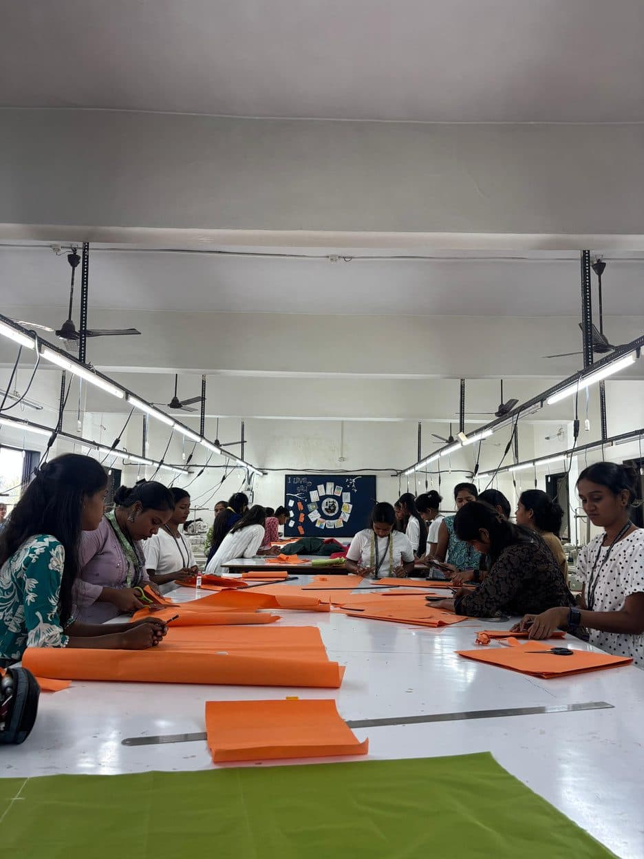 Students cutting patterns at long tables in the Pattern Making Lab
