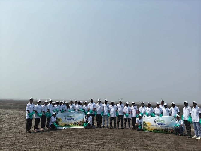 Students with banners on a beach during a Swachh Bharat Abhiyan clean-up